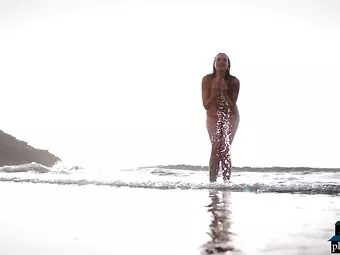 German MILF beauty Jasmin Furry gives a striptease on the beach for Playboy