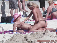 German tourists kiss sensually on the beach